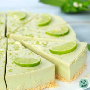 Lime no bake cheesecake sliced with fresh limes