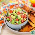 a bowl of keto guacamole with keto tortilla chips