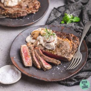 steak sliced on a plate with mushroom sauce