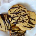 cookies on bakig parchment drizzled with sugar-free chocolate