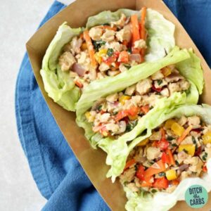 Thai chicken lettuce wraps served in a cardboard take out box