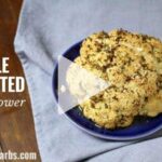 A whole roasted cauliflower brushed with butter and herbs