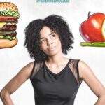 a woman in a black top with a burger and an apple in the air