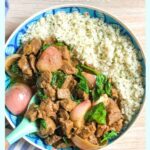 beef rendang served with cauliflower rice in a blue and white dish
