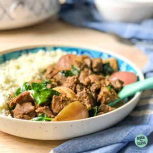 beef rendang served with cauliflower rice in a blue and white dish