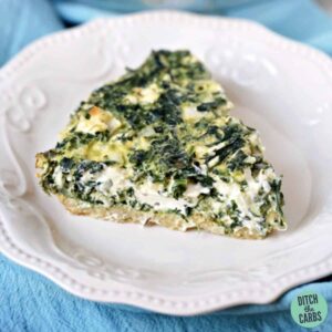 a slice of keto spinach pie on a white plate