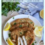 keto pork schnitzel recipe cooked and served with wedges of fresh lemons