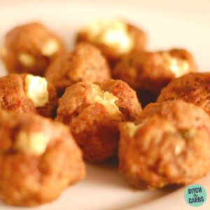 A plate of cream cheese stuffed meatballs ready to be served with sauces