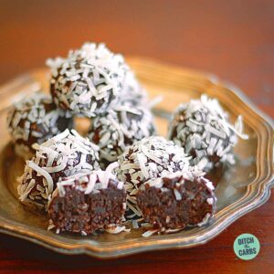 a selection of chocolate energy balls sitting on a fluted silver plate