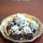 a selection of chocolate energy balls sitting on a fluted silver plate