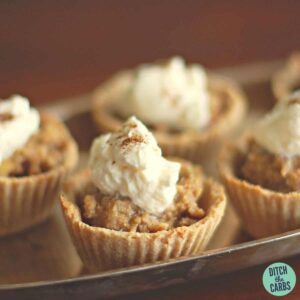 low-carb Christmas fruit pies served on a silver platter with whipped brandy cream