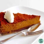 Slice of chocolate pumpkin pie with an antique silver fork and spoon