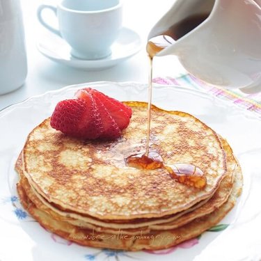 Sugar free bakewell tarts dusted with icing sugar on a white plate