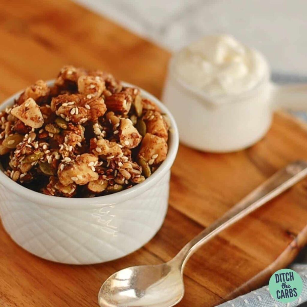 nutty grain free granola on a wooden board and silver spoon