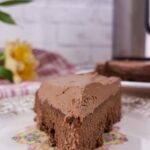Low-carb Instant Pot chocolate cake sliced and served with frosting