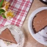 Low-carb Instant Pot chocolate cake sliced and served with red towel and flowers