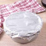 Instant pot chocolate cake batter and a cake tin wrapped with foil about to be cooked