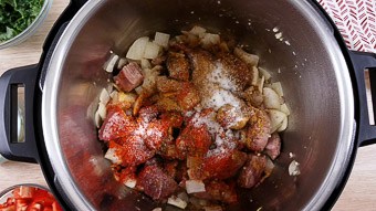 The instant pot bowl filled with lamb herbs and spices for the lamb curry dinner