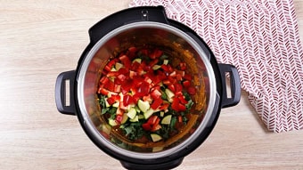 The instant pot bowl filled with lamb herbs and spices for the lamb curry dinner