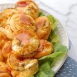 Salmon and cream cheese bites on a plate with lettuce