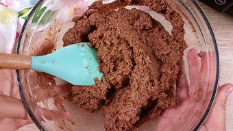 Mixing the chocolate cake lava cake batter with a blue spoon