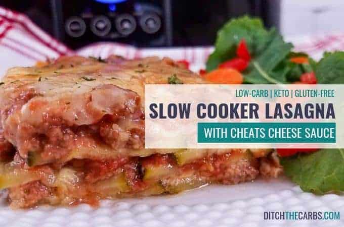 Slow cooker lasagne served on a white plate with a side salad