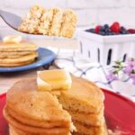 Almond flour pancakes stacked and cut being eaten with a fork