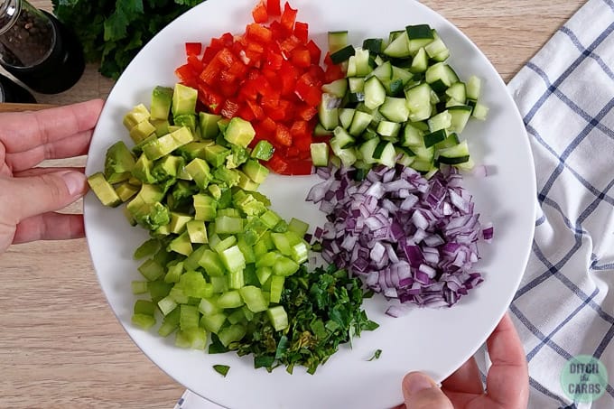 A bowl of salad ingredients on a plate 