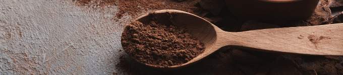 cocoa powder in a wooden spoon