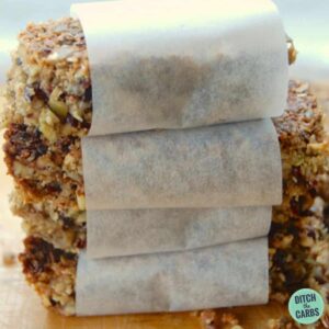 grain-free granola bars wrapped in baking paper and placed on a wooden chopping board