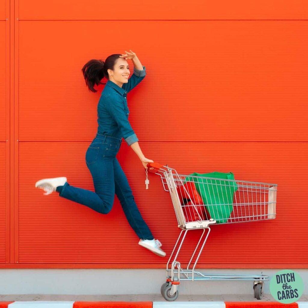 women in jeans jumping with a shooping trolley