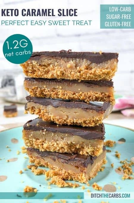 5 pieces of keto caramel slice stacked on top of each other on an aqua colored plate.