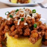 Low-carb Sloppy Joes meat served over a 1-minute muffin on a white plate.