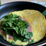 Keto Reverse Omelette with ham and spinach before folding in half