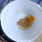 A mixing bowl with sweetener peanut butter and an egg