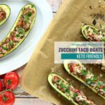 2 cooked zucchini taco boats on a white plate and served with salsa and cheese