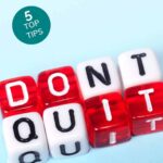 lettered dice spelling "don't quit" in red and white
