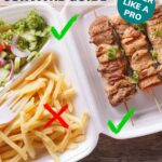 take out container with chicken kebabs and fries