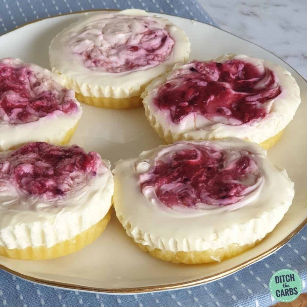 mini no bake cheesecakes on a white plate and blue cloth