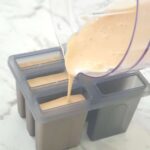 pouring ice cream into popsicle moulds