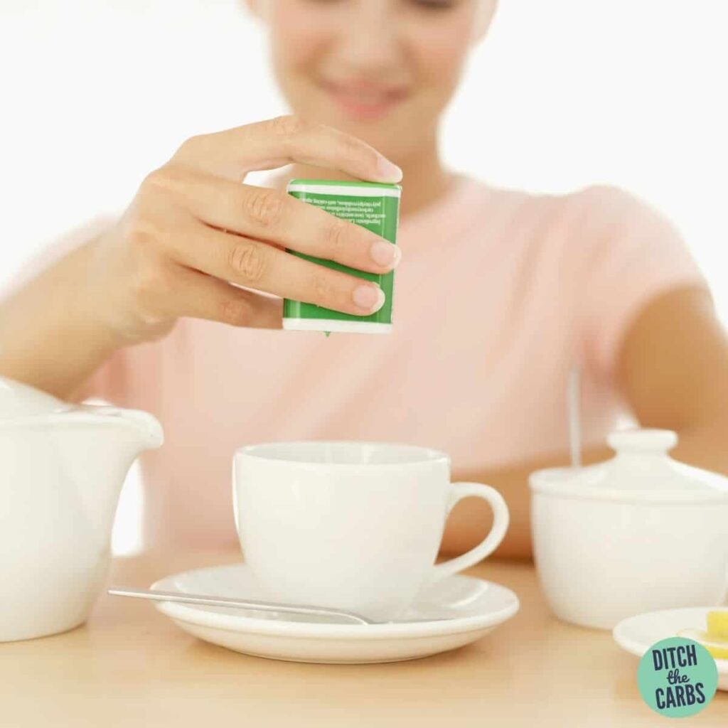 woman putting sweetener in her tea