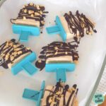 keto peanut butter ice cream blocks sitting on a glass dish and a blue cloth