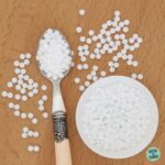 sweetener tablets in a spoon and white bowl