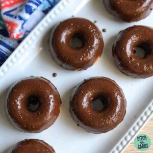 Six almond flour keto donuts resting on a white serving tray.