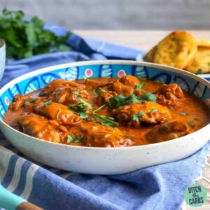 keto butter chicken being served in a shallow dish topped with cilantro.