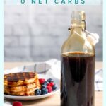 a bottle of homemade sugar-free keto maple syrup and gluten-free waffles