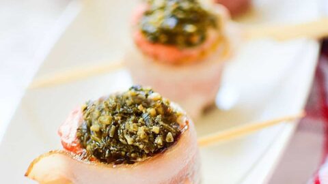 Bacon Wrapped Salmon Pesto Recipe on a black plate