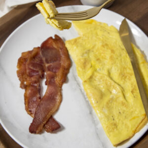Low-carb breakfast, basic cheese omelet with bacon