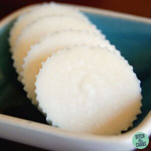 4 coconut fat bombs sitting on a small blue dish