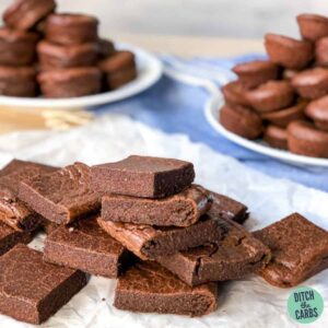 keto chocolate walnut brownies sliced and piled high on a white plate